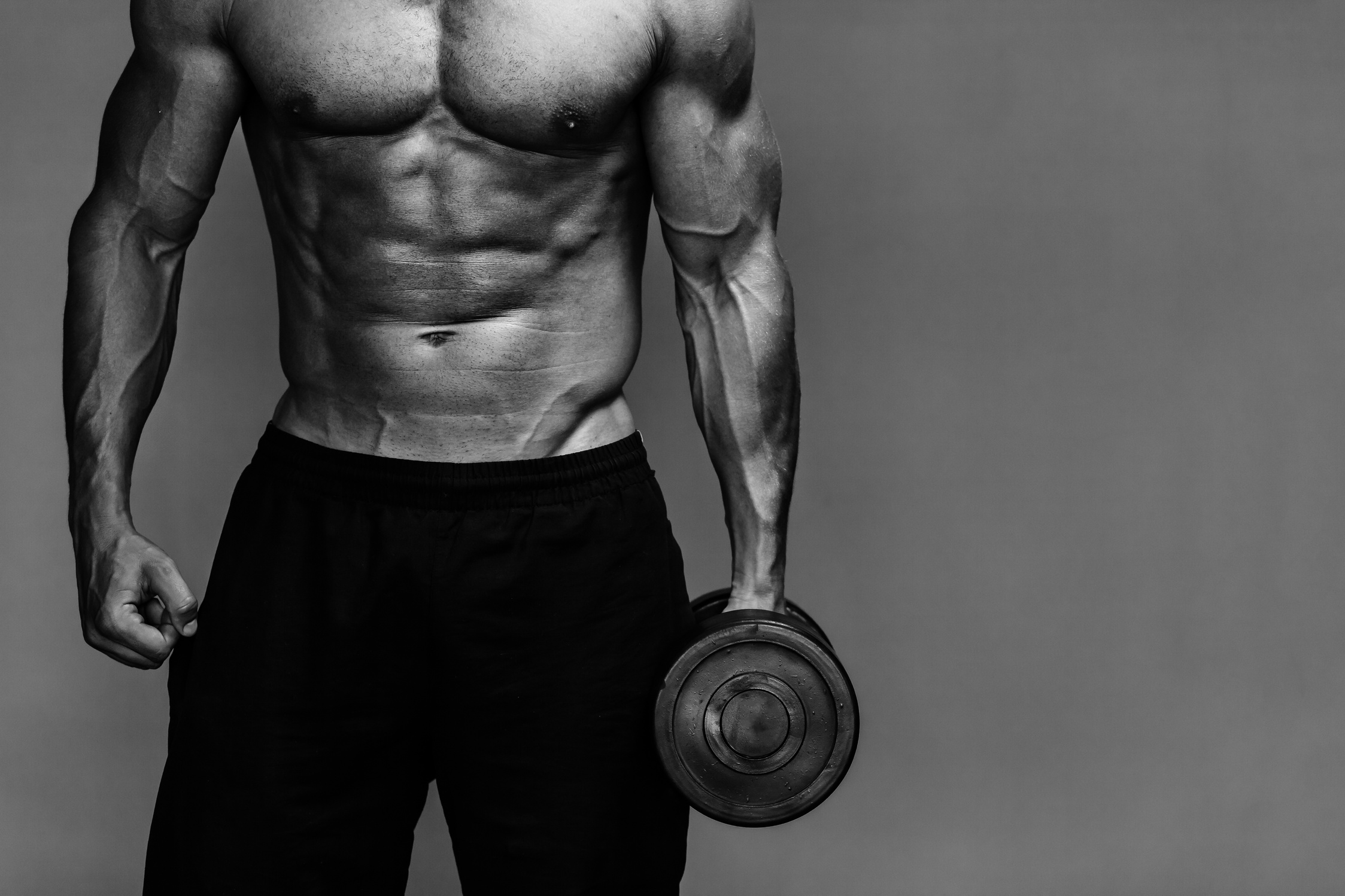 Muscular Bodybuilder Holding a Dumbbell